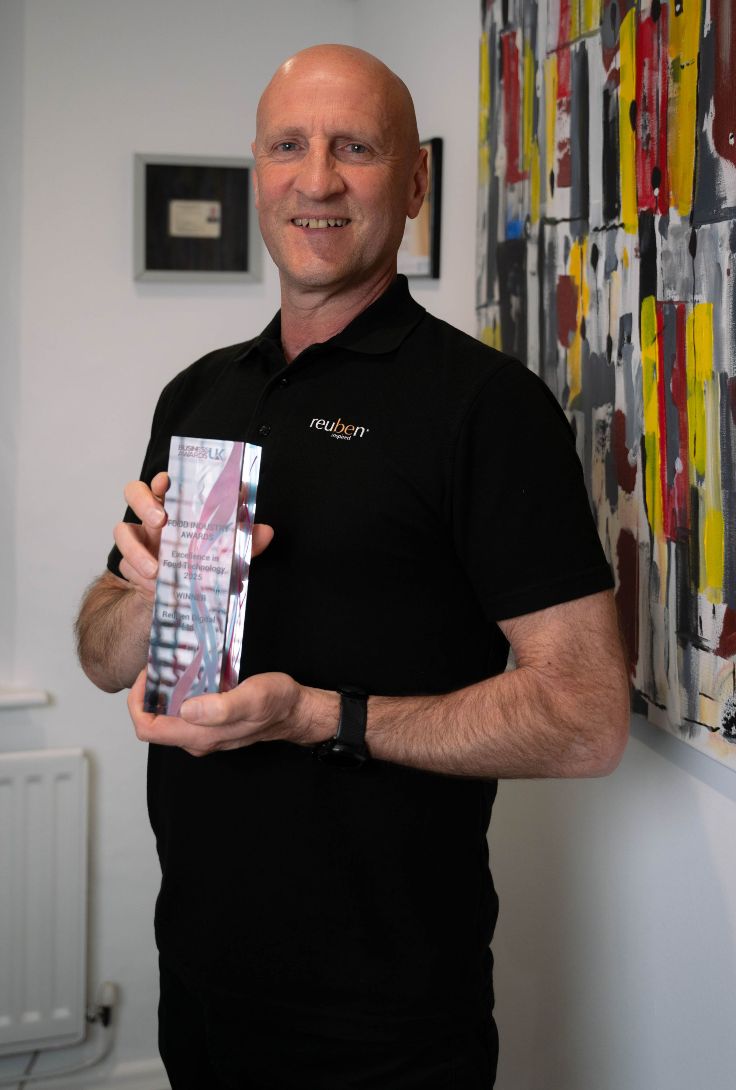 Ray holding Business Award UK trophy